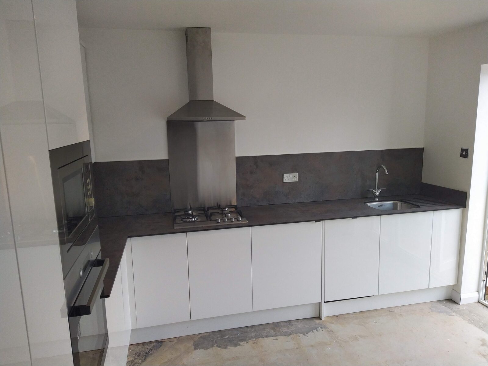 Modern white gloss kitchen run with integrated appliances