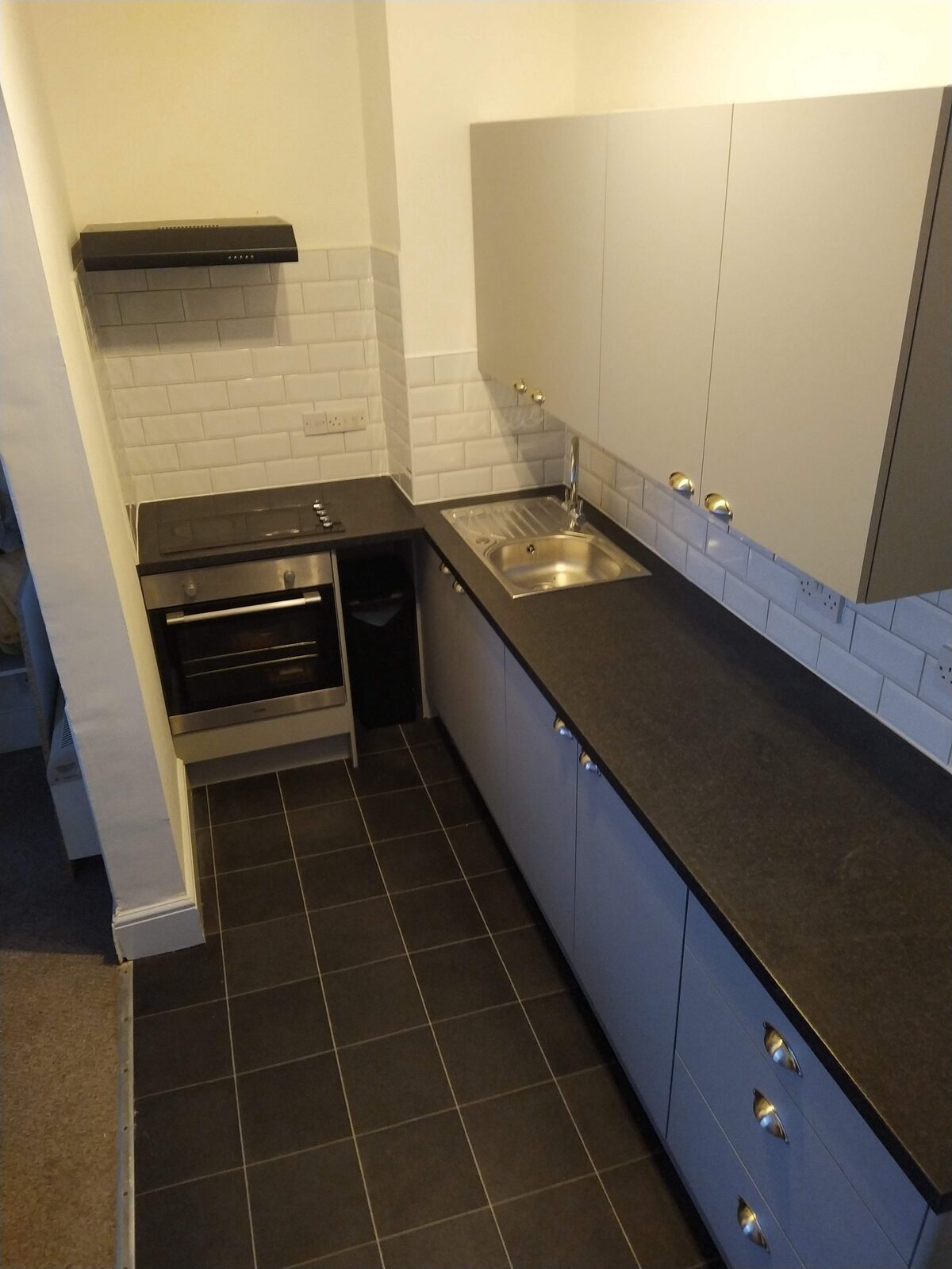 Compact rental kitchen with metro tile splashback